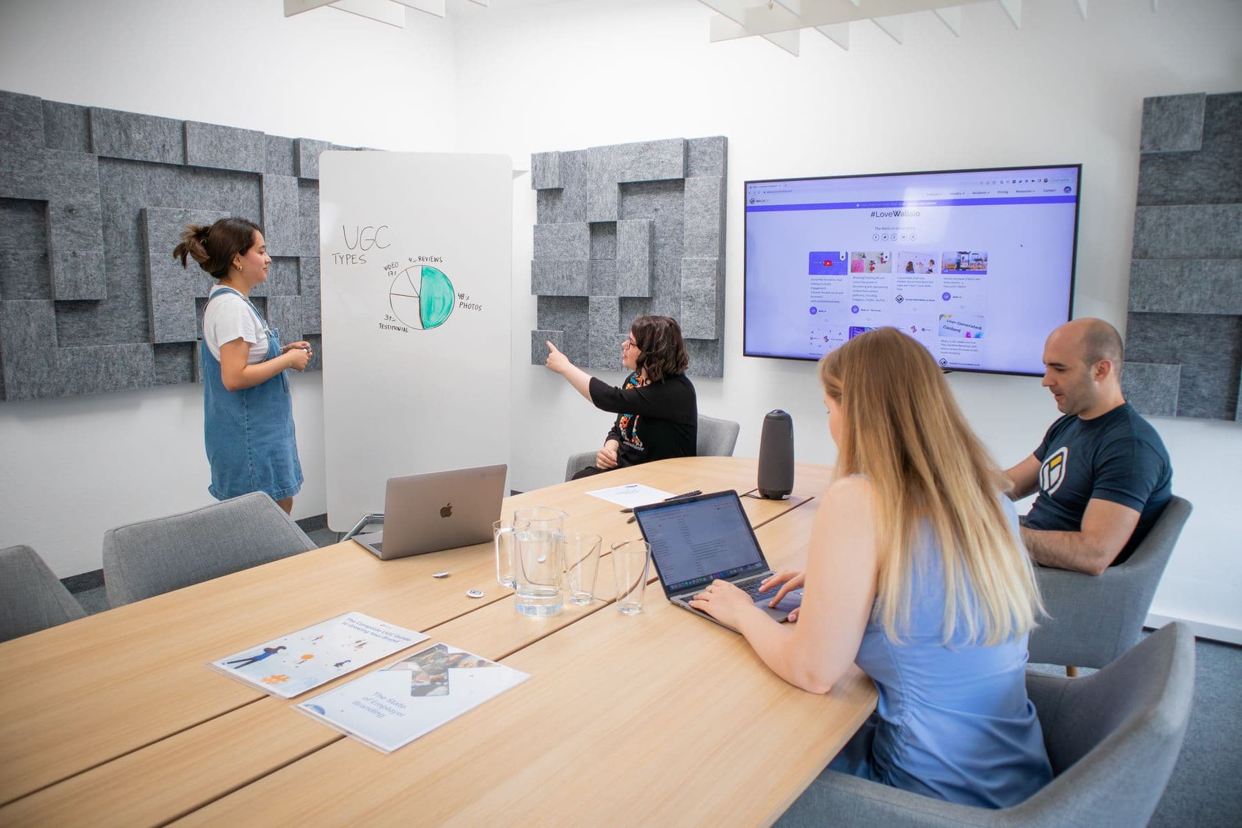 A marketing team reviewing strategy and audience evidence in a modern workshop